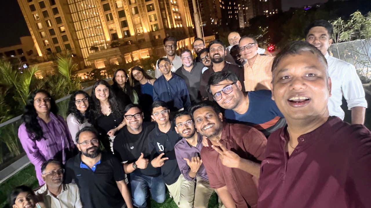 Selfie at the eChai Founders Dinner at Zestard HQ: founders of eChai Partner Brands gathered on a rooftop with a lit-up city skyline behind them